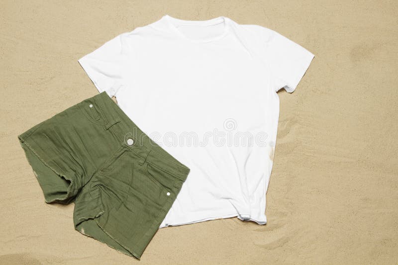 Mockup white not wrinkled summer t-shirt copy space. Sand beach texture background. Blank template woman man shirt Top view.