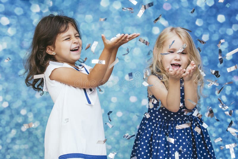 Mode mit zwei kleinen Mädchen Kindermit silbernen Konfettis im backg