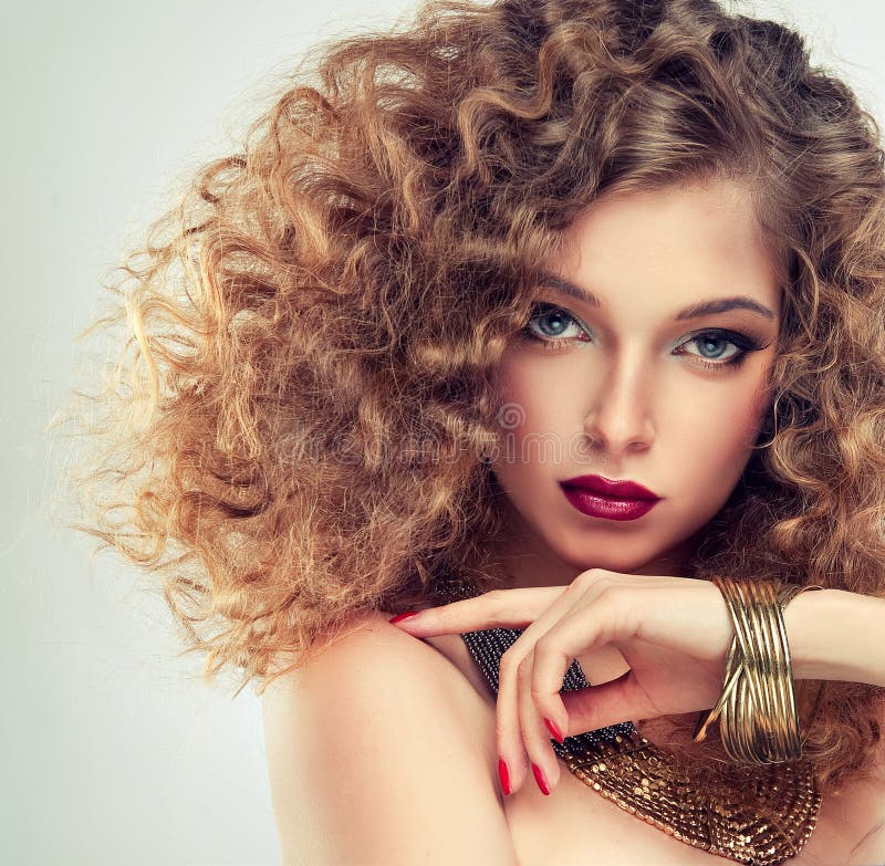 Model with curly hair.