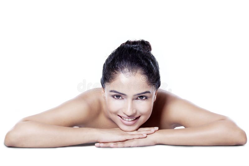 Portrait of beautiful asian girl with black hair and healthy skin lying down on her hands after spa treatment. Portrait of beautiful asian girl with black hair and healthy skin lying down on her hands after spa treatment