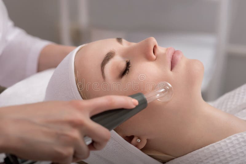 Model geting cleansing peeling rejuvenating facial treatment in a beauty SPA salon