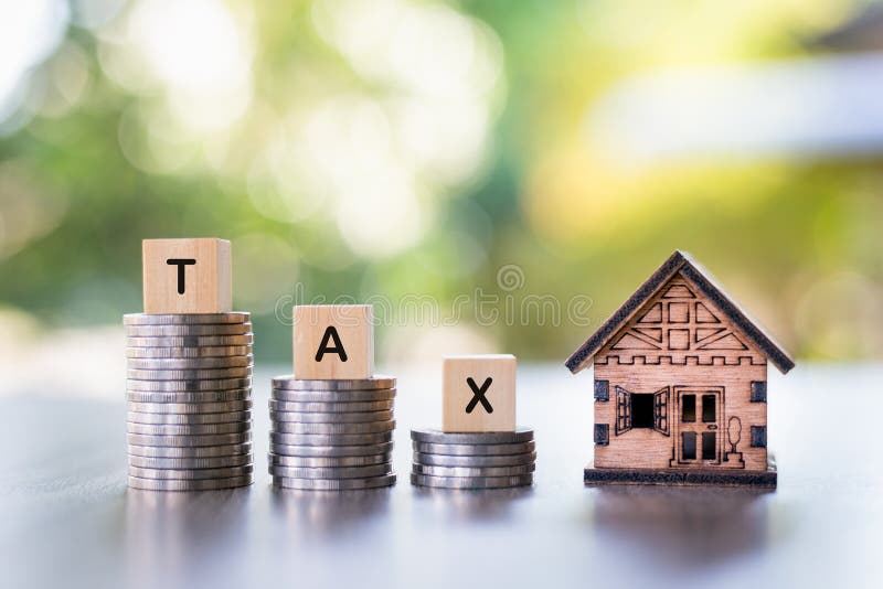 A model house, the word tax is placed on top of the coin pile. House tax. Housing tax.