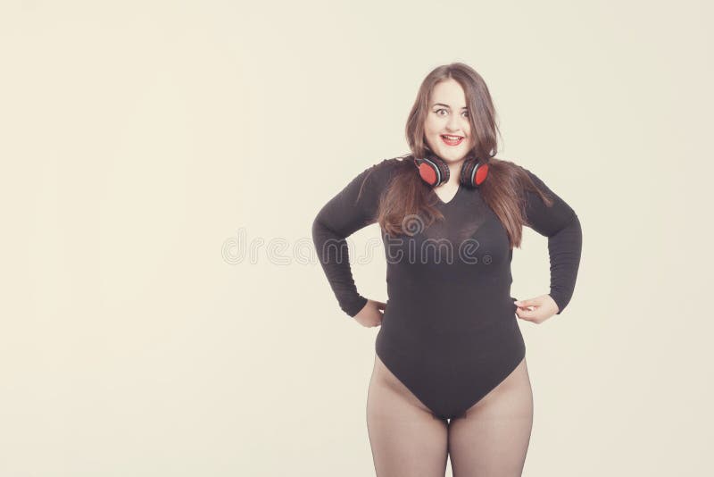 Model Plus Size with Sweet Donut, Happy Girl Posing with Headphones and  Listen Music, in Black Bodysuit. XXL Female Sitting on Stock Image - Image  of model, plus: 140991825