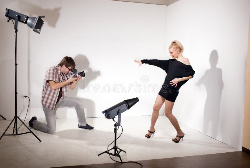 Model poses for photographer in photo studio