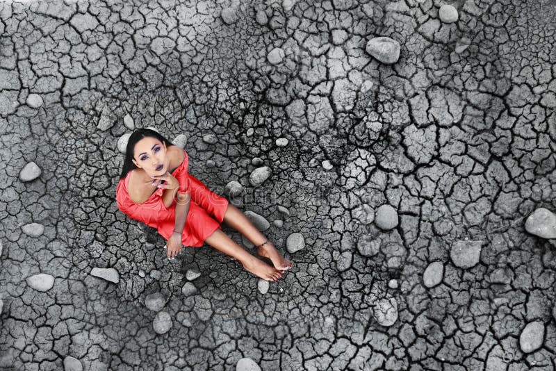 Download The Model Sits On The Dried Soil Stock Image - Image of clothing, alone: 109096005