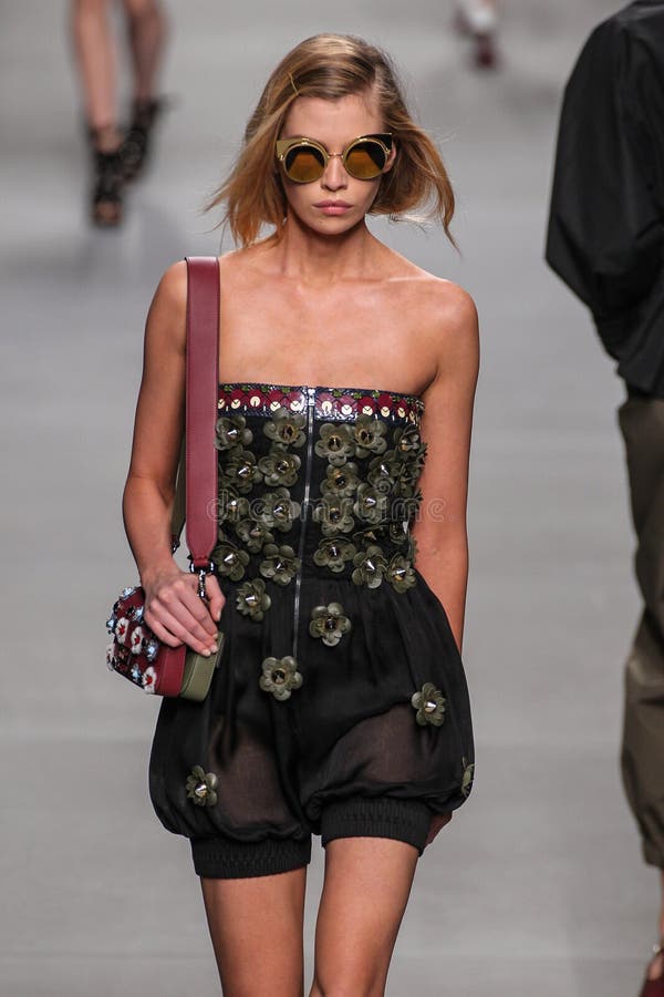 A model, sunglasses detail, walks the runway at the Fendi fashion