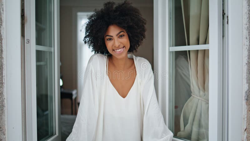 Modello africano che guarda il ritratto di casa. donna positiva che cattura gocce di pioggia fotografia stock libera da diritti