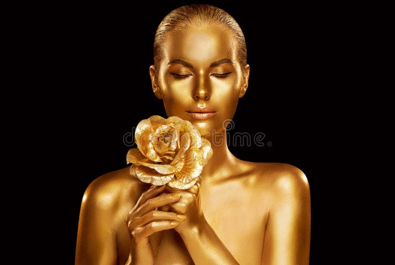 Gold Fashion Model Beauty Portrait with Rose Flower, Golden Woman Art Luxury Makeup on studio black background. Gold Fashion Model Beauty Portrait with Rose Flower, Golden Woman Art Luxury Makeup on studio black background