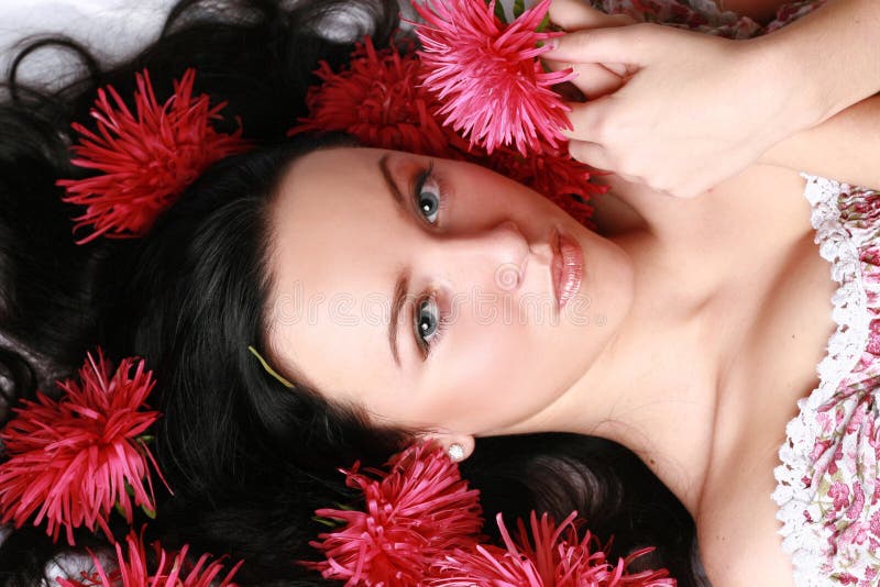 Portrait of a beautiful model in red flowers. Portrait of a beautiful model in red flowers.