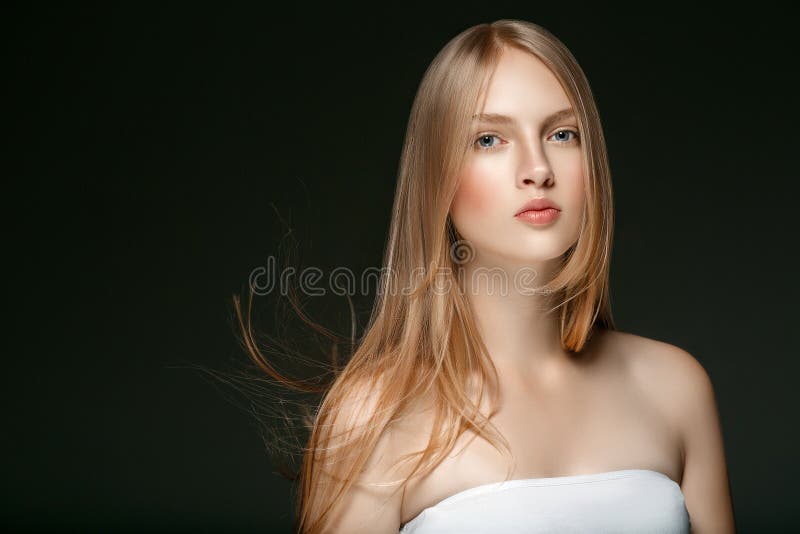 Beautiful Blonde Woman Beauty Model Girl with perfect makeup and hairstyle over black background. Beautiful Blonde Woman Beauty Model Girl with perfect makeup and hairstyle over black background.