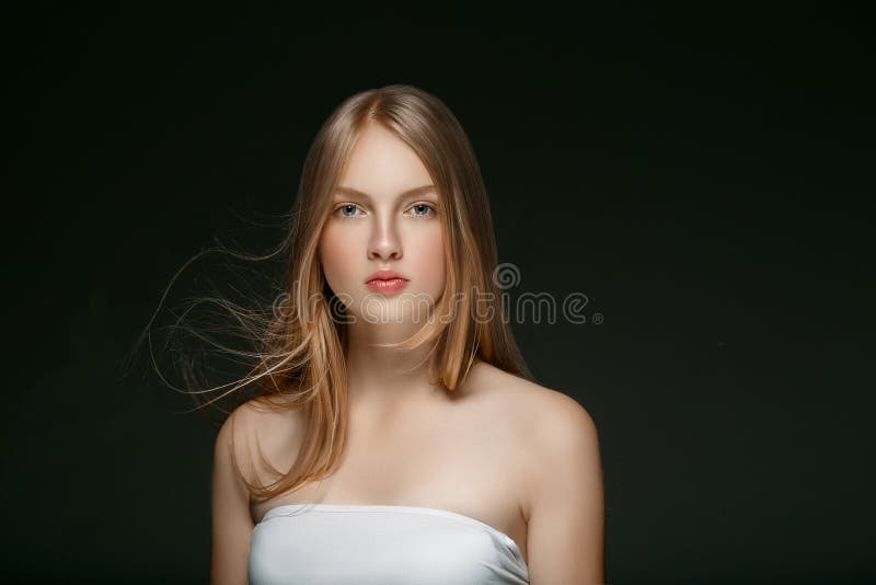 Beautiful Blonde Woman Beauty Model Girl with perfect makeup and hairstyle over black background. Beautiful Blonde Woman Beauty Model Girl with perfect makeup and hairstyle over black background.