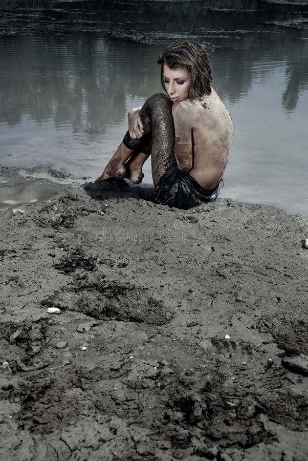 Woman sitting in the dirty place at the lake. Woman sitting in the dirty place at the lake