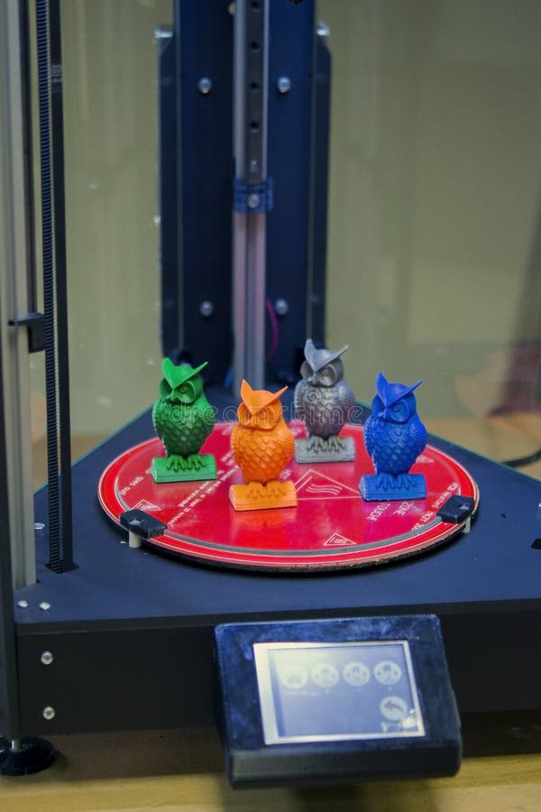 Models in the form of owls stand inside a three-axis 3d printer royalty free stock photography