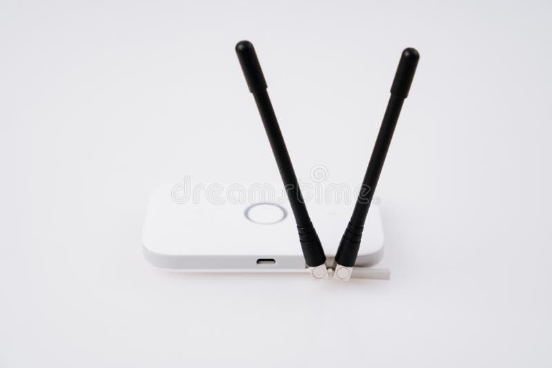 mobile modem and black antennas on a white table. The device has an internal SIM card slot for a home network supported by 3G, 4G technology. Wi-Fi is used to send an Internet signal. mobile modem and black antennas on a white table. The device has an internal SIM card slot for a home network supported by 3G, 4G technology. Wi-Fi is used to send an Internet signal