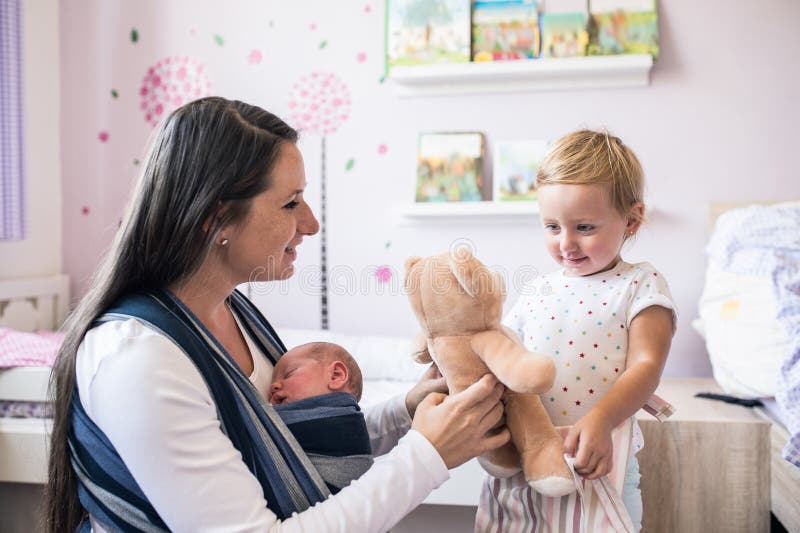 Moder med sonen i rem och dotter med nallebjörnen royaltyfri fotografi Moder med sonen i rem och dotter med nallebjörnen royaltyfri fotografi