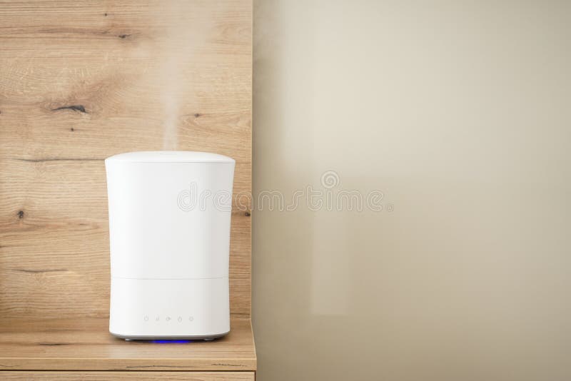 Modern Air Humidifier on the Bedside Table in the Bedroom, Space for