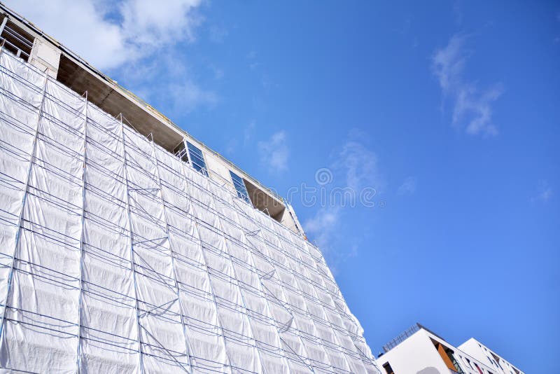 Scaffolding with Canvas Covers on Construction Site Residential
