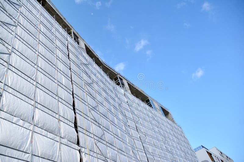 Scaffolding with Canvas Covers on Construction Site Residential