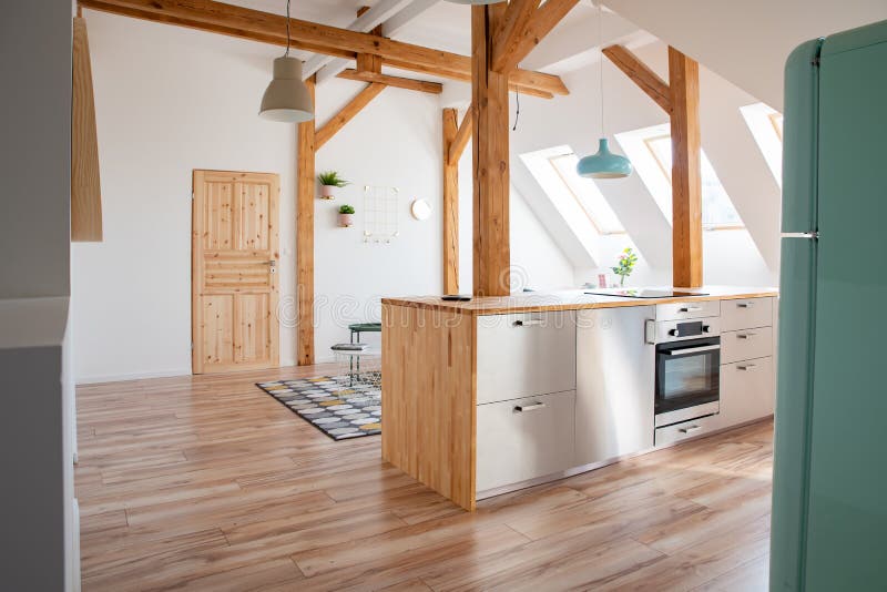 Modern attic white bright kitchen in the loft apartment royalty free stock photo