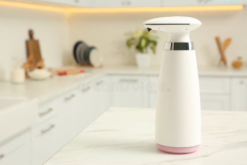 Modern Automatic Soap Dispenser on Countertop in Kitchen. Space for