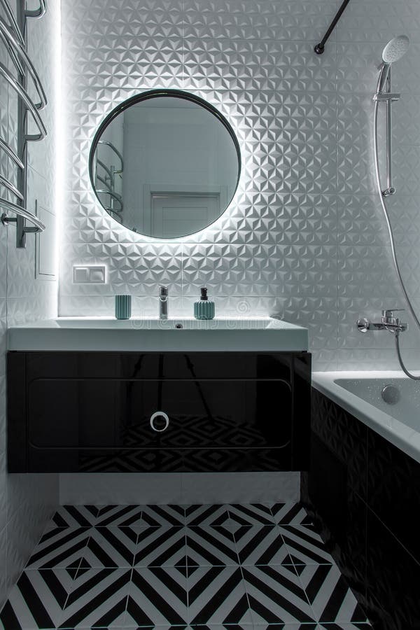 A Modern Bathroom with a Black Vanity, Mirror, and Hardware. Stock
