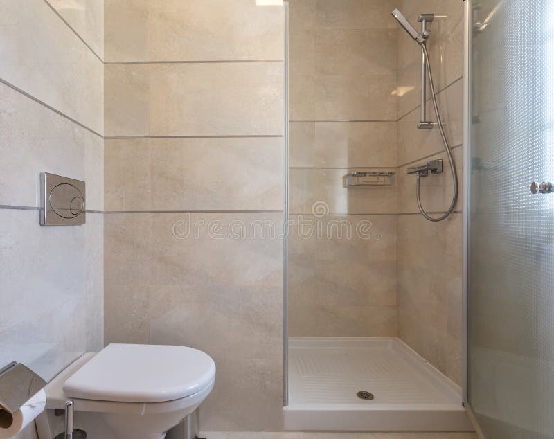 Modern Bathroom Shower Room with Toilet and Amenities. Stock Photo