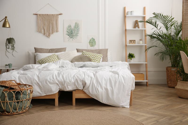 Modern bedroom with beautiful fresh house plants royalty free stock images