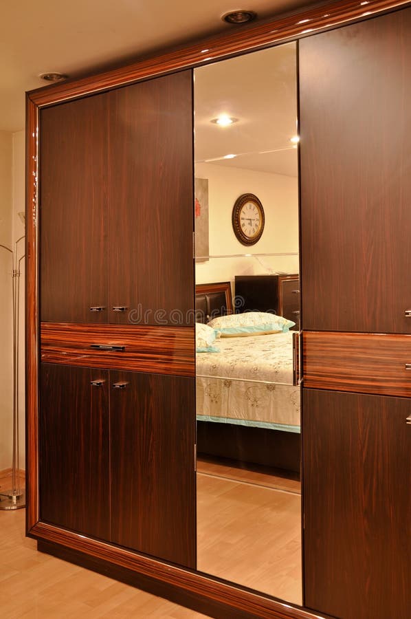 Brown wardrobe in bedroom stock photo. Image of home 130223356