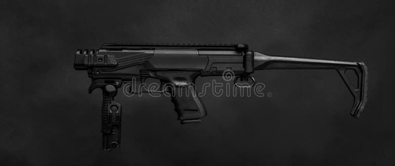 Modern black submachine gun on a black royalty free stock photos