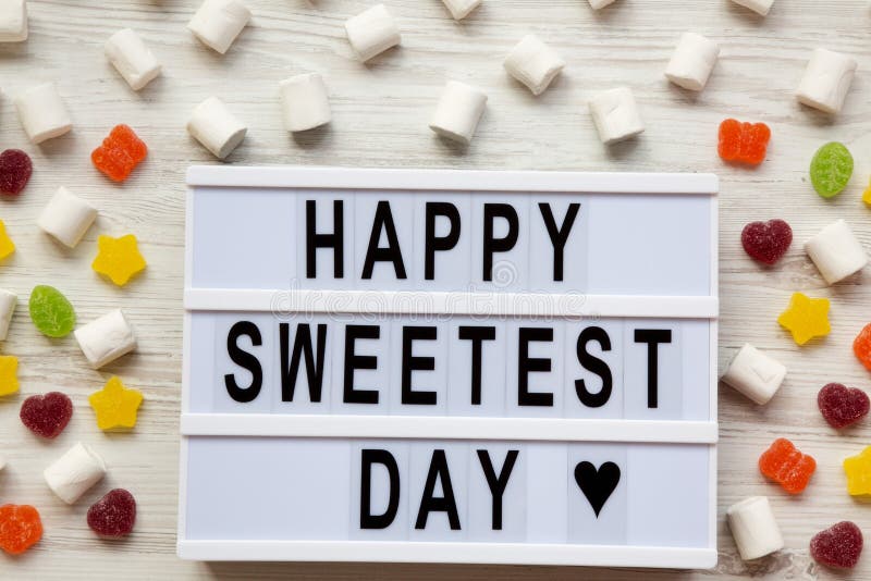 `Happy Sweetest Day` Word on Modern Board Over White Wooden Background ...