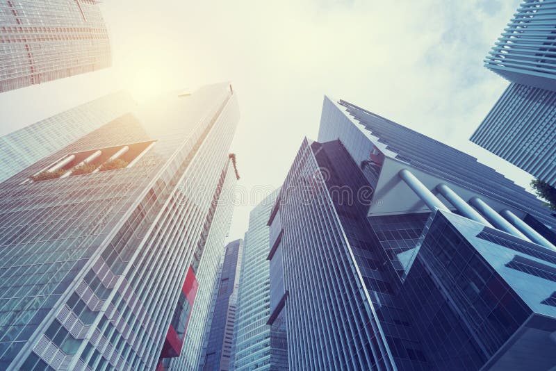 Modern building at business center city. Look up view with sunlight. Architecture, construction, investment, finance. Abstract background.