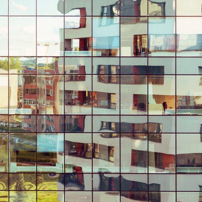 Modern building reflected on glass facade