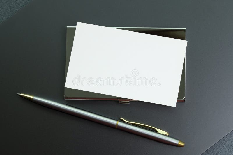 Modern business desk with clock, pen and business cards stock photo