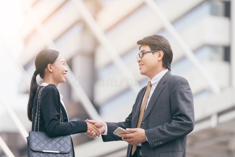 Modern Business people deal.partners shake hands, standing in front of his office. city background royalty free stock photography Modern Business people deal.partners shake hands, standing in front of his office. city background royalty free stock photography