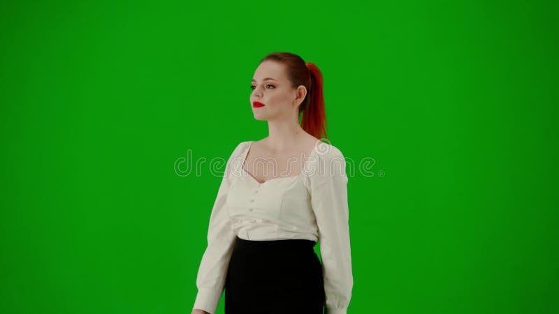 Portrait of attractive office girl on chroma key green screen. Woman in skirt and blouse walking cutely. Half turn.
