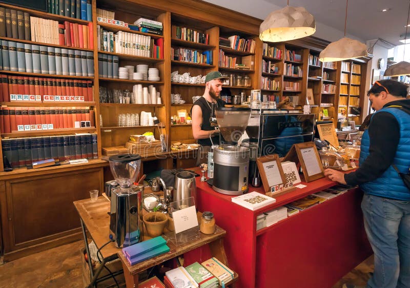 Modern cafe inside old bookstore with readers and people buying snacks for breakfast royalty free stock photography Modern cafe inside old bookstore with readers and people buying snacks for breakfast royalty free stock photography