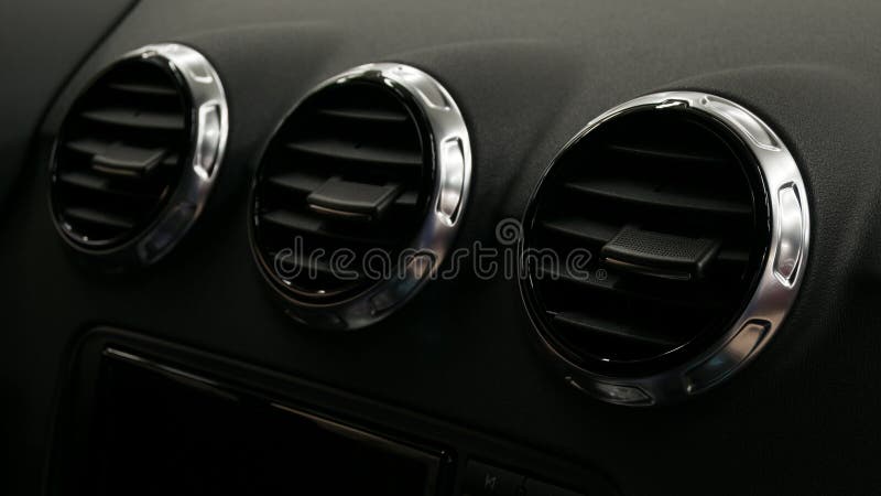 Modern car interior detail. Air conditioning holes. stock photo