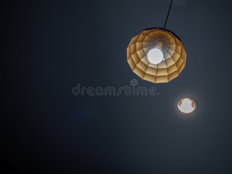 Modern Ceiling Light Hanging from Ceiling in Dark Room Stock Image