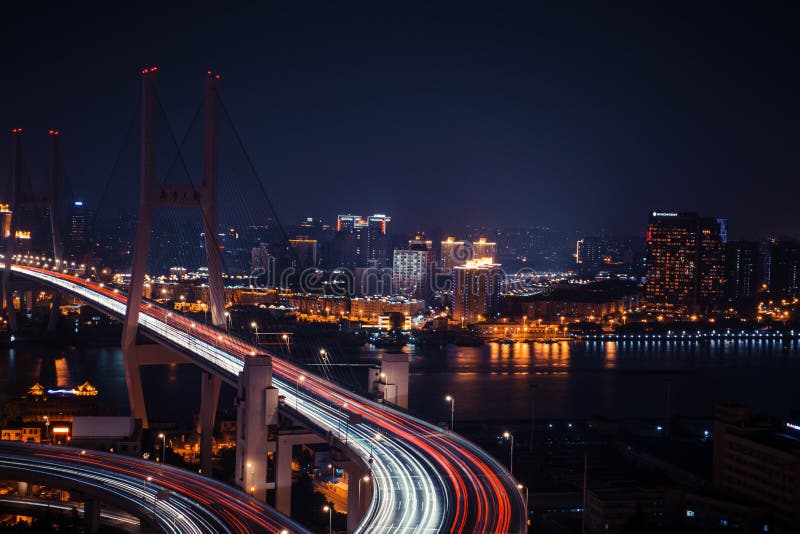 Modern city traffic road at night. Transport junction.