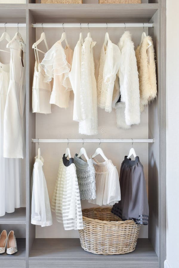 Modern closet with row of white dress and shoes hanging in wardrobe