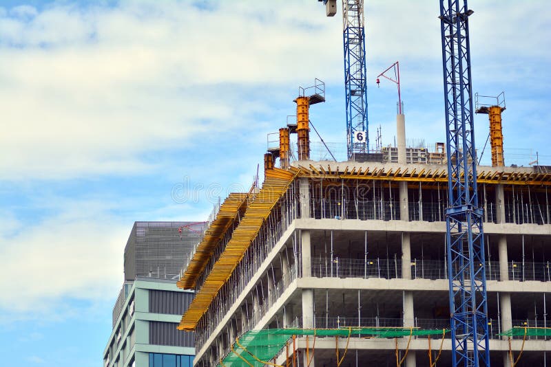 Modern building is under construction, metal scaffolding and sky. Concrete fragment stock images, royalty-free photos and pictures
