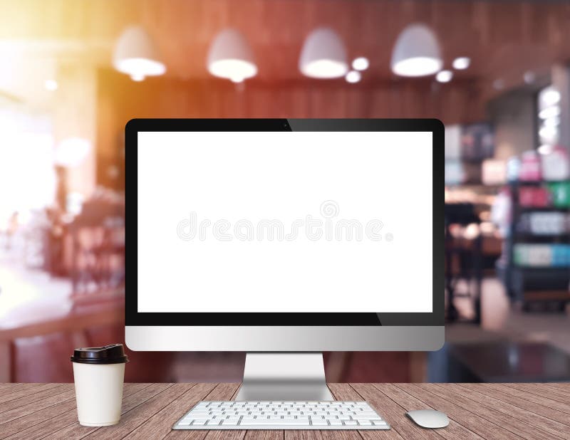 Modern Computer Monitor on a wooden desk with coffee shop royalty free stock image