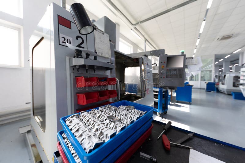 Modern Computerized Factory Equipment Processing Metal Parts Inside