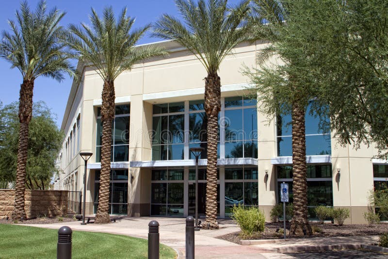 Modern corporate office building entrance in office park.