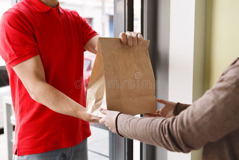 Modern Delivery of Any Order Girl Takes Package from Hands of Courier Modern Delivery of Any Order Girl Takes Package from Hands of Courier