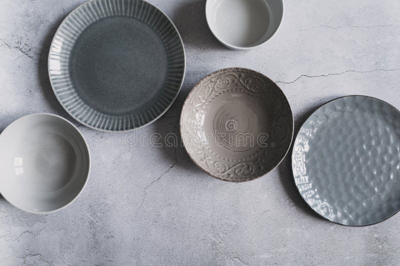 Modern dishware collection in rustic grey and beige tones. royalty free stock images