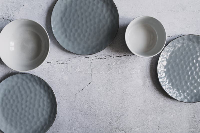 Modern dishware collection in rustic grey and beige tones. stock photography
