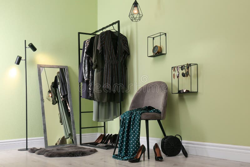 Modern Dressing Room Interior with Clothing Rack, Chair and Mirror