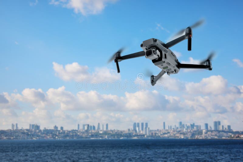 Modern Drone Flying Over Sea and Blurred Cityscape on Background ...
