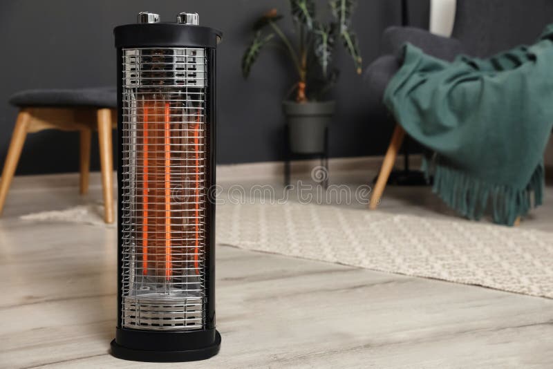 Modern Electric Halogen Heater on Floor in Room Interior Stock Photo